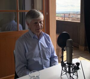 Walter Klin recording the Human Rights Podcast; behind him Nuremberg's skyline