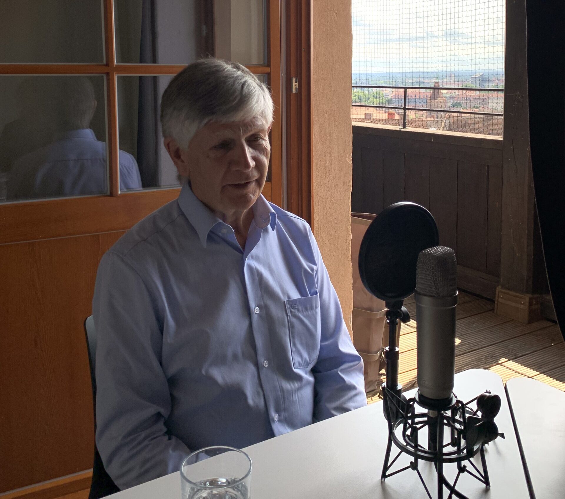 Walter Klin recording the Human Rights Podcast; behind him Nuremberg's skyline